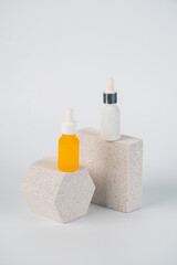 Plastic yellow tube for cream or lotion. Skin care or sunscreen cosmetic with stylish props on white background.