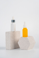 Plastic yellow tube for cream or lotion. Skin care or sunscreen cosmetic with stylish props on white background.