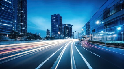 Obraz premium A bustling city street at night with illuminated buildings and moving vehicles, featuring blue and white lights, a blue sky, and a blurred foreground with streaks of light.