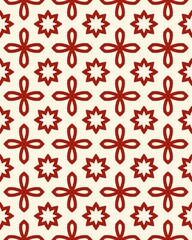 A detailed geometric textile featuring red floral designs against a cream background, creating a striking visual effect