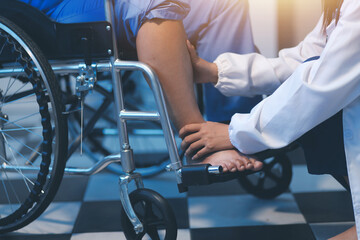 Obraz premium Asian young professional successful friendly female nurse in blue hospital uniform helping supporting physical therapy senior old pensioner unhealthy injury woman patient walking via four legs walker.