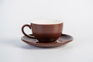 Brown coffee cup and coffee plate on white background
