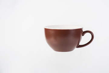 Brown coffee cup and coffee plate on white background