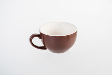 Brown coffee cup and coffee plate on white background