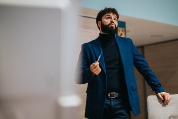 A businessman wearing a stylish suit holds an informational session at an office desk. The atmosphere communicates professionalism, confidence, and teamwork within a corporate environment.