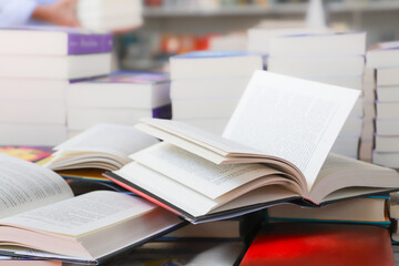 stack of books, close up. Open book on the table in library. Back to school concept.