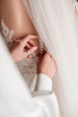 The bride's morning, wedding preparations, dressing the bride.