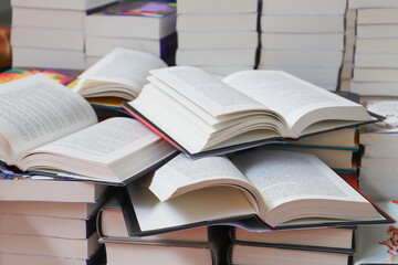 stack of books, close up. Open book on the table in library. Back to school concept.