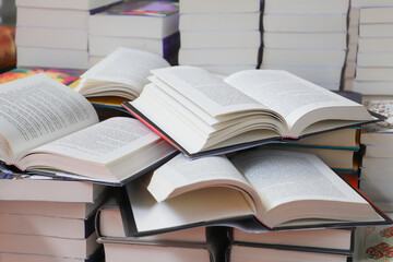stack of books, close up. Open book on the table in library. Back to school concept.