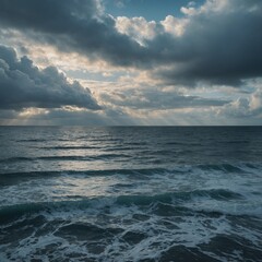 Obraz premium Golden light paints the ocean and sky as the sun descends on the horizon, a serene seascape of water meeting the colorful clouds