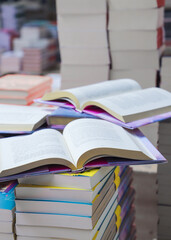 stack of books, close up. Open book on the table in library. Back to school concept.