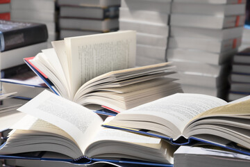 stack of books, close up. Open book on the table in library. Back to school concept.