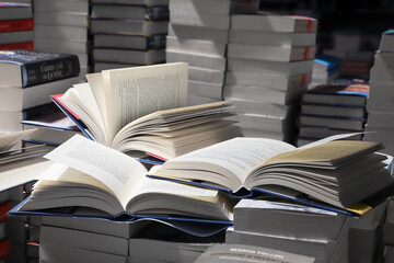 stack of books, close up. Open book on the table in library. Back to school concept.