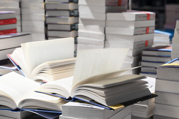 stack of books, close up. Open book on the table in library. Back to school concept.