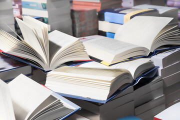 stack of books, close up. Open book on the table in library. Back to school concept.