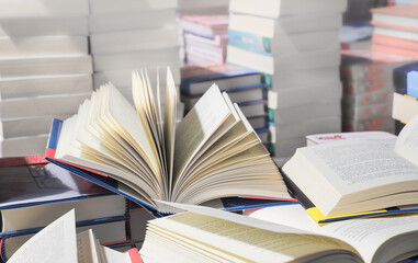 stack of books, close up. Open book on the table in library. Back to school concept.