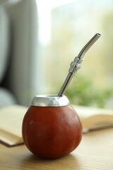 Traditional yerba mate tea on wooden table indoors