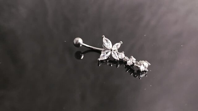 Belly button earrings with stones and a pendant in the shape of cannabis leaves. summer decoration. Piercing