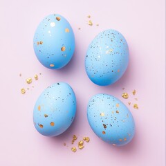 Fototapeta premium Four pastel blue eggs, gold speckled, arranged on a pale pink background