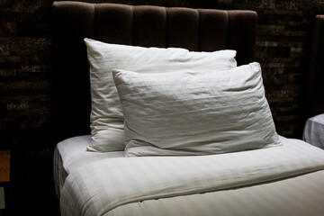 A white bedding and pillows in hotel