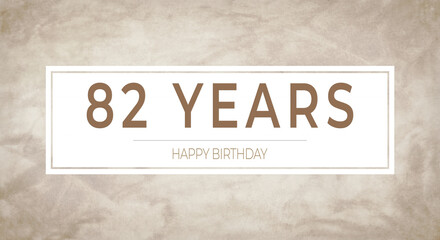 Obraz premium Beige textured background with bold “82 YEARS” typography framed in white — perfect for milestone birthday cards, anniversary invitations, celebratory banners and party designs.