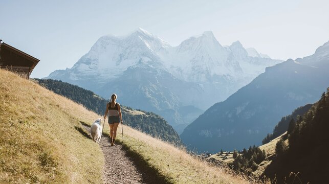 Pet friendly travel in the Swiss Alps with a woman and her border collie exploring picturesque hiking trails