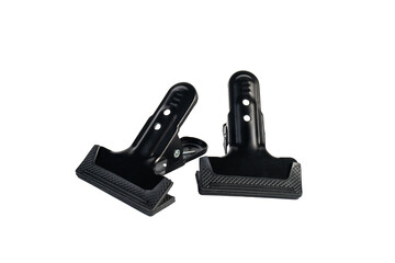 Black plastic spring clamp isolated on transparent background.