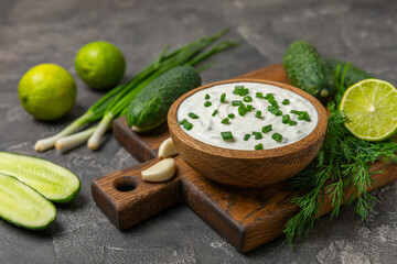 Cucumber sour cream tzatziki sauce on a wooden table.Tartar sauce. Traditional delicious appetizer. yogurt sauce. Tzatziki with ingredients cucumber, garlic,dill,lemon,mint. salad dressing.Copy space