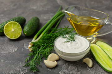Cucumber sour cream tzatziki sauce on a wooden table.Tartar sauce. Traditional delicious appetizer. yogurt sauce. Tzatziki with ingredients cucumber, garlic,dill,lemon,mint. salad dressing.Copy space
