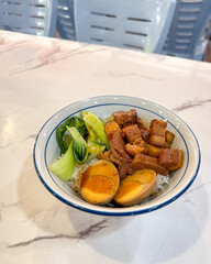 Cooked rice with braised pork belly and egg, ready to eat