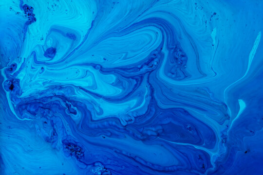 Fluid blue hues blend creatively to form striking patterns