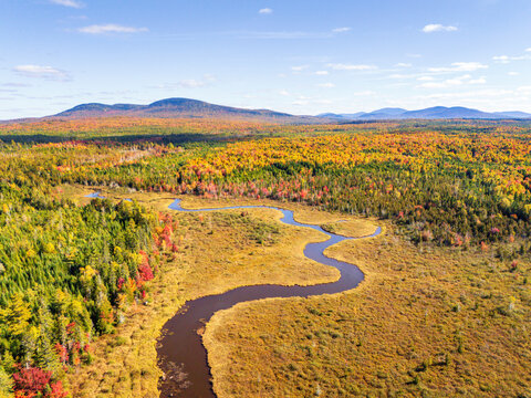 Aerial view of a winding river through fall foliage in Maine, USA