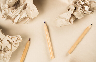 Creative workspace with colored pencils and crumpled paper on a simple surface in a calm setting