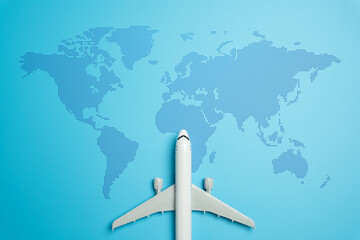 Passenger plane and world map. Passenger transportation and international flights. Tourism and travel. International mobility, tourism growth, and the logistics of global passenger transport.