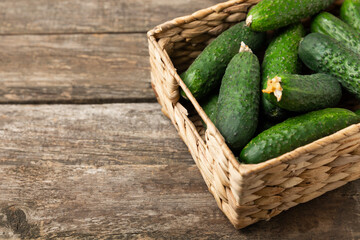 Cucumber on wooden background. Slice of cucumber on background. Fresh organic green cucumbers gherkin. Vegan. Salad ingredient. Farm vegetables. Cut vegetables with knife. Space for text. Copy space