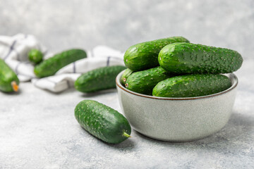 Cucumber on wooden background. Slice of cucumber on background. Fresh organic green cucumbers gherkin. Vegan. Salad ingredient. Farm vegetables. Cut vegetables with knife. Space for text. Copy space