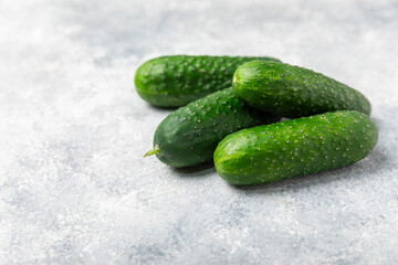 Cucumber on wooden background. Slice of cucumber on background. Fresh organic green cucumbers gherkin. Vegan. Salad ingredient. Farm vegetables. Cut vegetables with knife. Space for text. Copy space