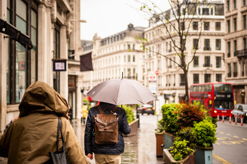 Regent Street- Defocussed central London retail street scene in wet rain weather conditions