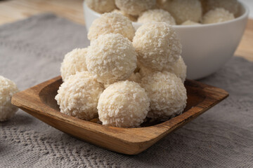 Coconut candies pile, coco ball. White truffle ball, indian ladoo or laddu with sweet cream and coco