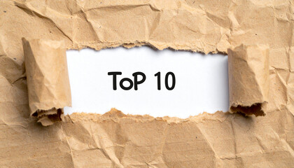 Torn paper revealing text Top 10. Business concept.