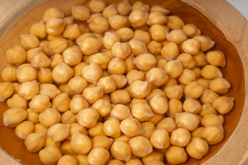 Soaked chickpeas, chick pea in water, swollen wet Cicer arietinum fruits, garbanzo beans cooking