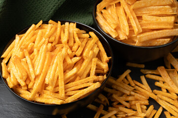 Fried chips sticks, finger potato chips, golden shoestring fries pile, French fries