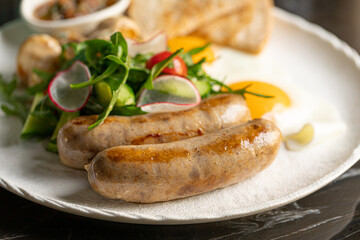 Closeup on portion of breakfast with sausages and fried eggs