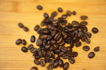 Close-up of roasted coffee beans on a wooden surface