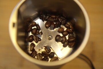 Coffee beans inside a grinder.