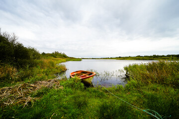View of the pond on the Danish island of Römo near Nörre Tvismark and the surrounding landscape.
