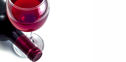 Glass and bottle of red wine close-up on white background.