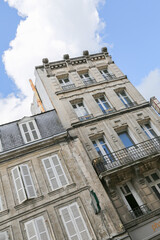 A large building with a balcony and awning in Cognac France