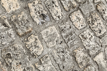 A close up of a brick sidewalk with a lot of texture