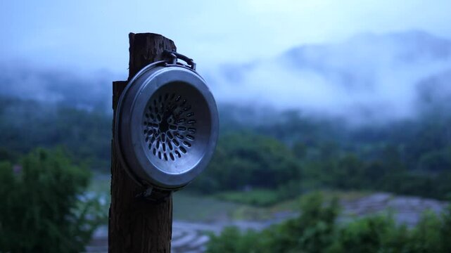 Moo Krata Grill Pan on Wooden Pole with Mountain and Foggy Nature Background &ndash; Thai Outdoor BBQ Atmosphere